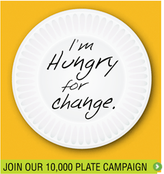 White paper plate that reads "I'm hungry for change." on a yellow background. At the bottom of the image, there is a green box that reads "join our 10,000 plate campaign"