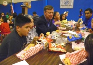 Governor Hickenlooper eats lunch with elementary school kids in an cafeteria