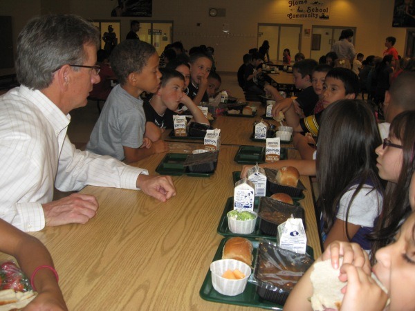Students and teachers eat lunch in a cafeteria