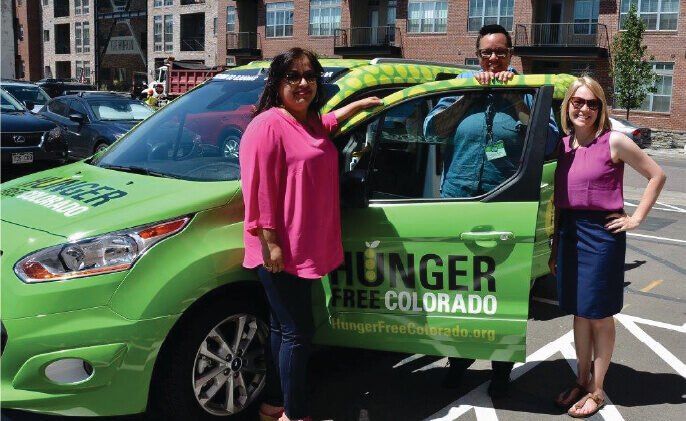 SNAP Outreach Group of people stand in front of a green car with 'Hunger Free Colorado' on the side